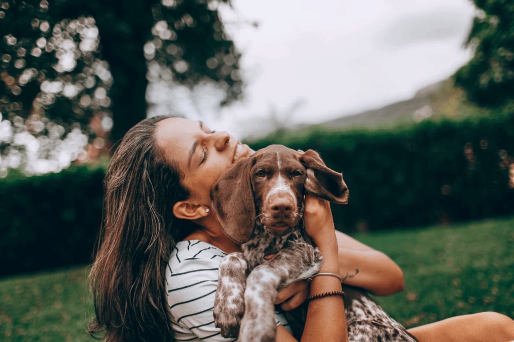 A-lady-holding-her-puppy-in-arms