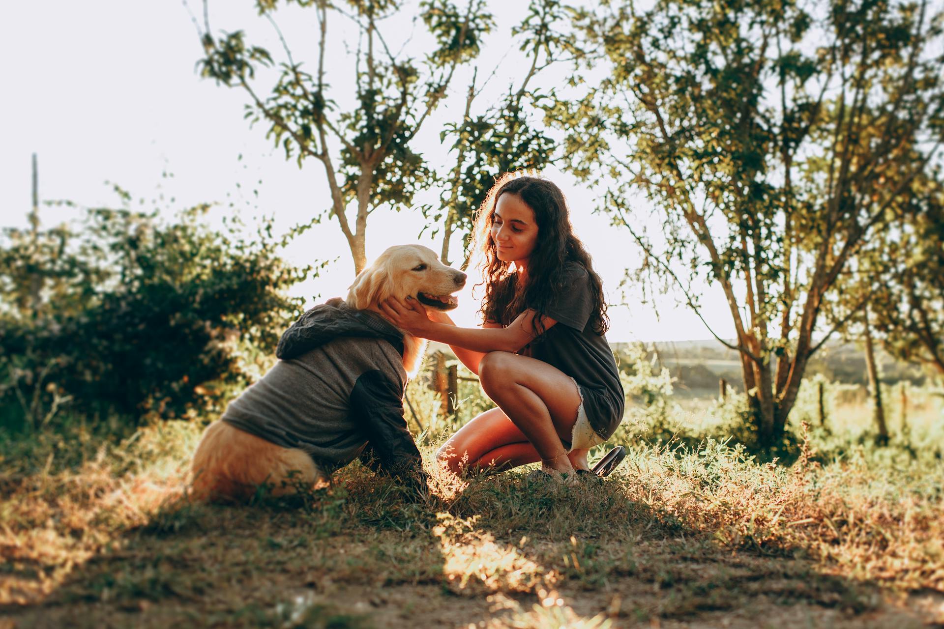 Girl with her dog sitting in jungle