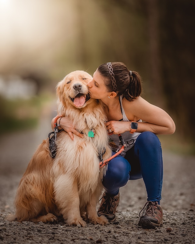 A woman kissing her dog